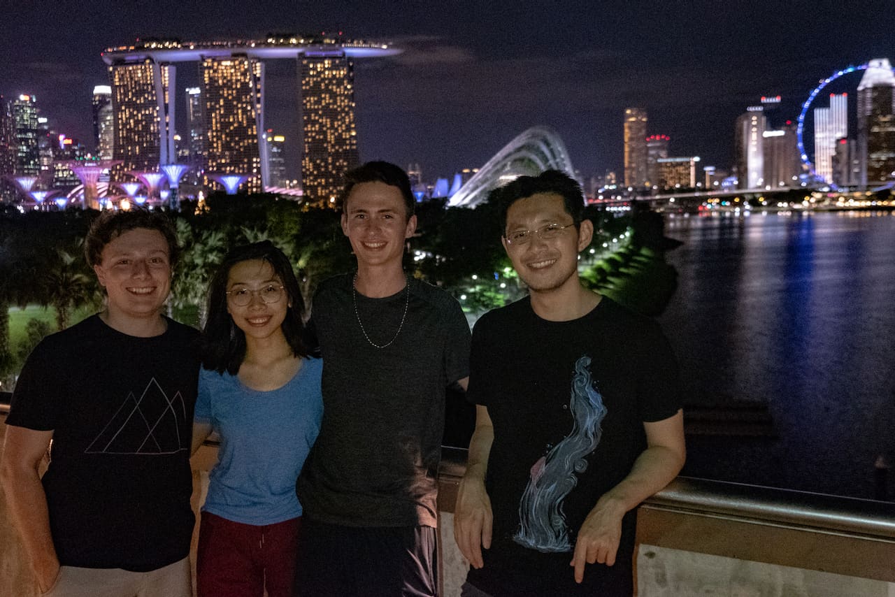 Friends beside Marina Bay in Singapore at night
